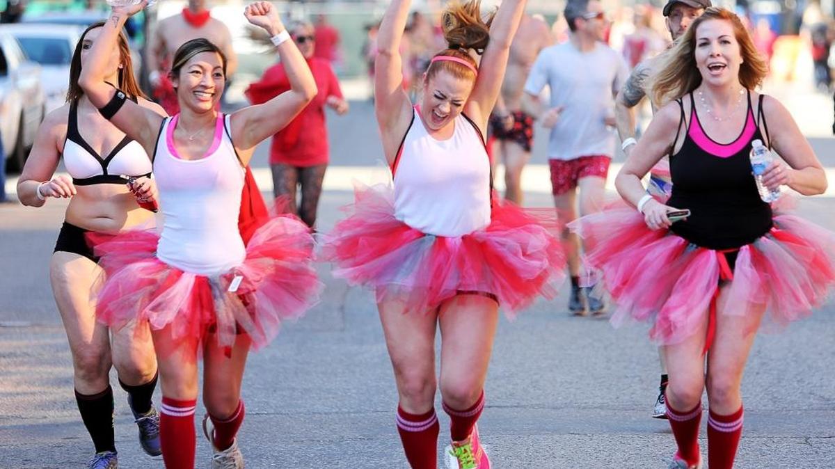Some of the hundreds of runners participating in the 2014 Cupid’s Undie Run approach the finish line in Boise.