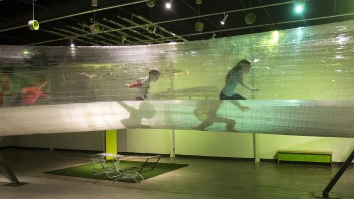 Children race through the “tape tunnel” at The Discovery Center.