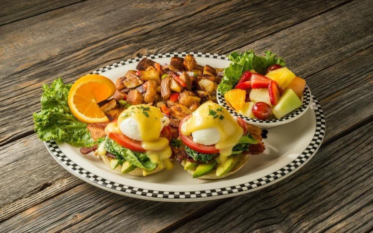 California Bacon Benedict ($10.99): Split English muffin, thick-cut sliced bacon, avocado, spinach, grilled tomato slices and two poached eggs covered in Hollandaise sauce.