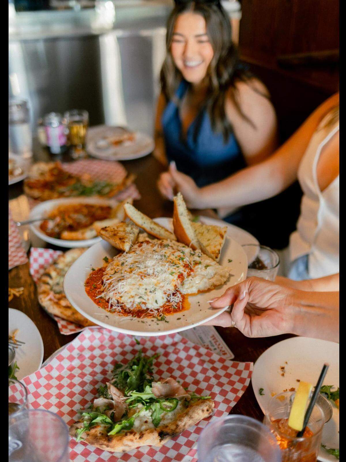 In addition to pizza, Red Bench serves pasta dishes such as chicken parmesan, pictured, along with sandwiches and more.