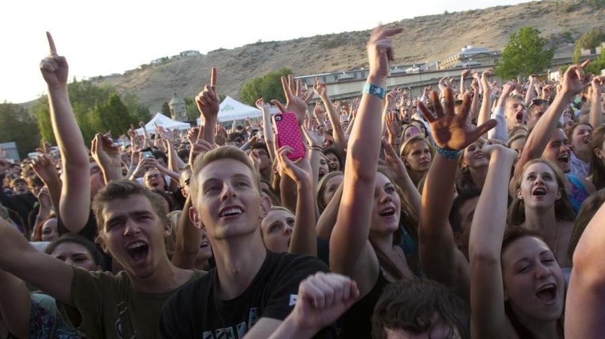 Front-row fans cheer at an Outlaw Field concert.