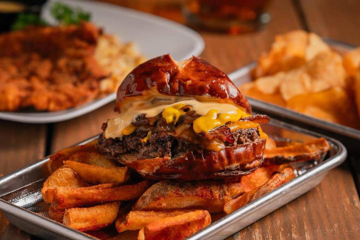 The food menu at Gather in Universal City includes a pretzel burger, served on a Slow Dough pretzel bun.