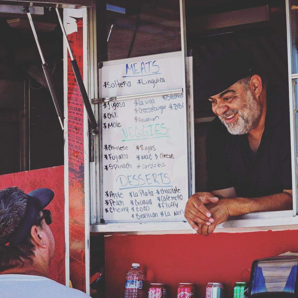 Tango’s co-owner Louis Bremmer serves a customer from the local brand’s food truck.