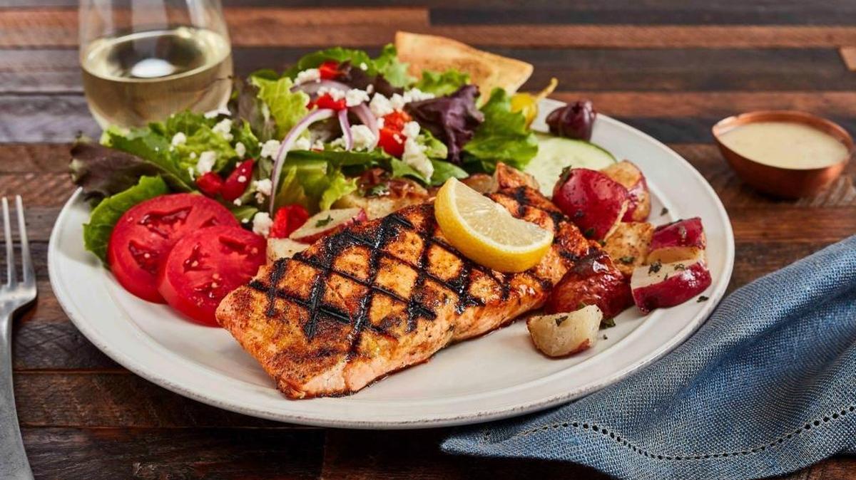 The Grilled Salmon Feast ($13.99) comes with a side of Greek salad and choice of basmati rice or potatoes.