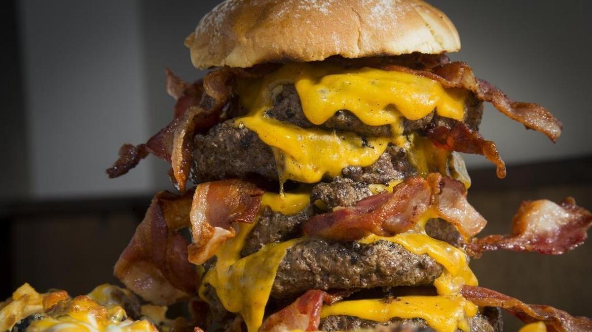 The Cow Tipper, a monstrously big hamburger at Homestead Bar and Grill in Meridian, is one of several local food challenges for hungry diners.