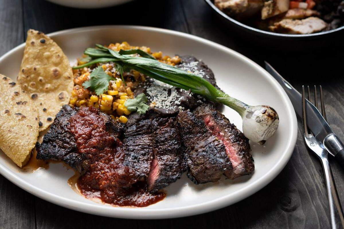 Carna Asada ($38), according to the menu, is “St. Helens skirt steak, spicy ancho chile salsa, chile–lime corn, refried black beans, queso blanco, grilled knob onion, housemade corn tortillas.”