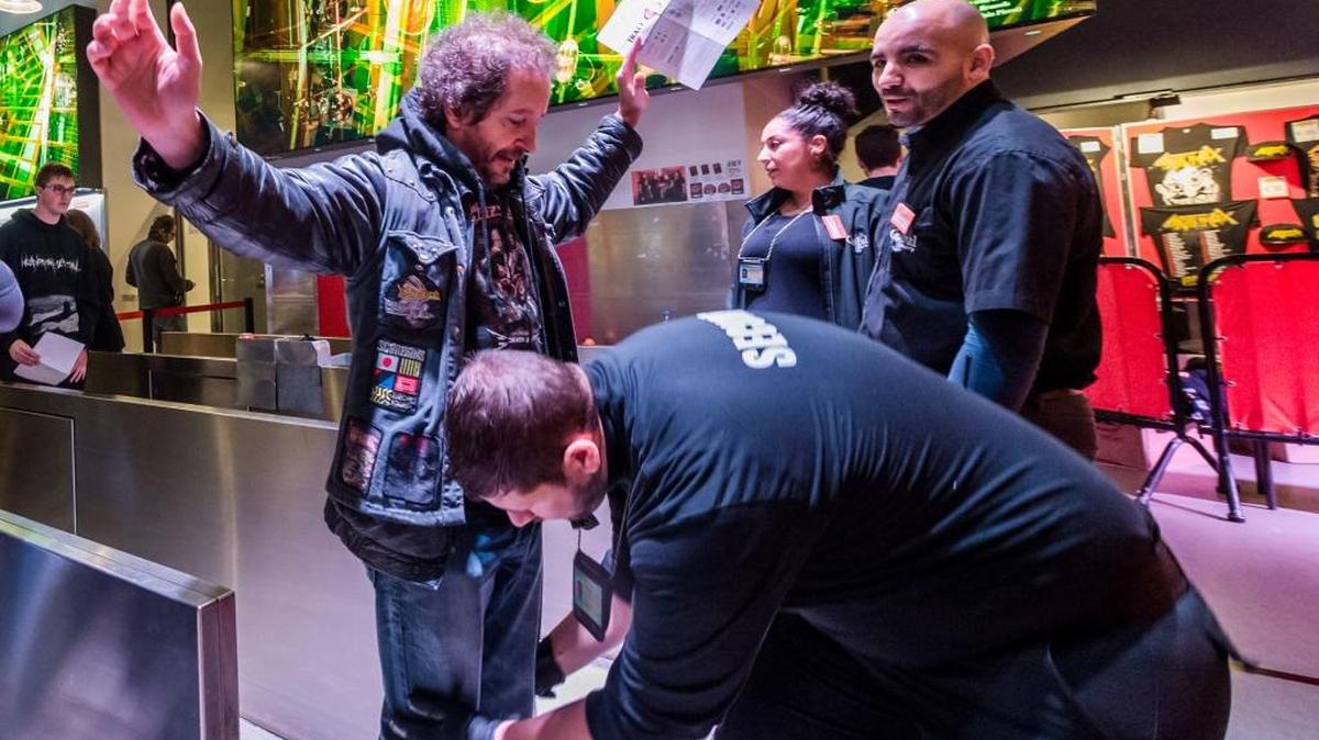 A security guard searches a fan of U.S. thrash metal band Slayer at the entrance of the Ancienne Belgique concert hall, in Brussels on Nov. 17. France has demanded that its European partners provide support for its operations against the Islamic State group in Syria and Iraq and other security missions in the wake of the Paris attacks.