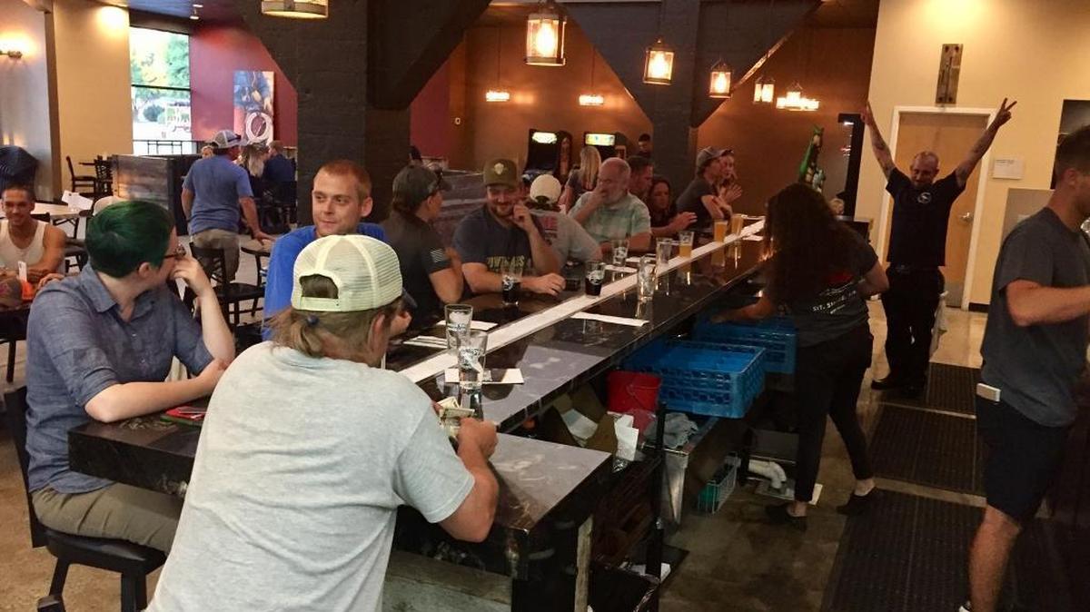 Patrons socialize at the bar at White Dog Brewing Co. in Boise.