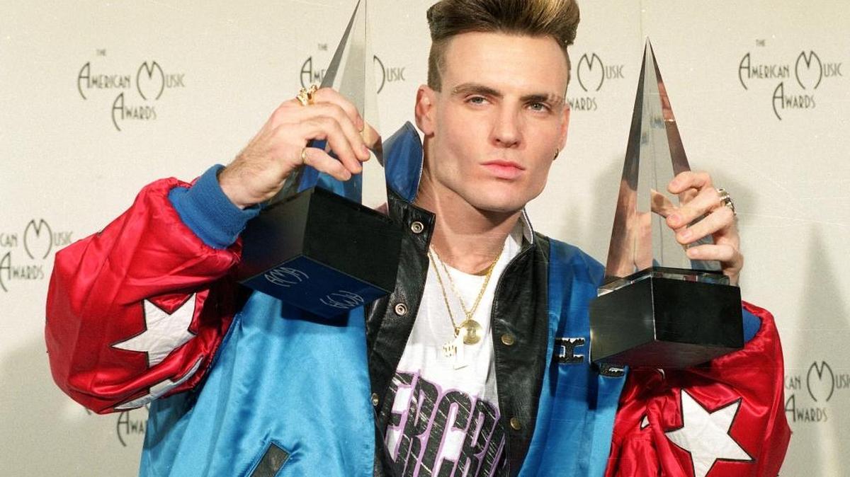 Word to your mother! In this 1991 photo, Vanilla Ice shows off awards he won in the rock and rap categories at the American Music Awards.