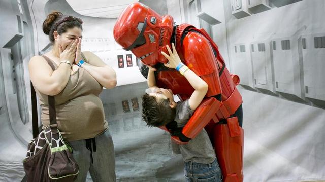 In this file photo, Connor Lindau, who has autism, hugs Adam Canon, dressed as a Magma Trooper from Star Wars, as Connor’s mother, Crystal Landau (left) watches during the first day of the Tree City Comic Con. “He (Connor) is just in heaven being here,” Crystal said.