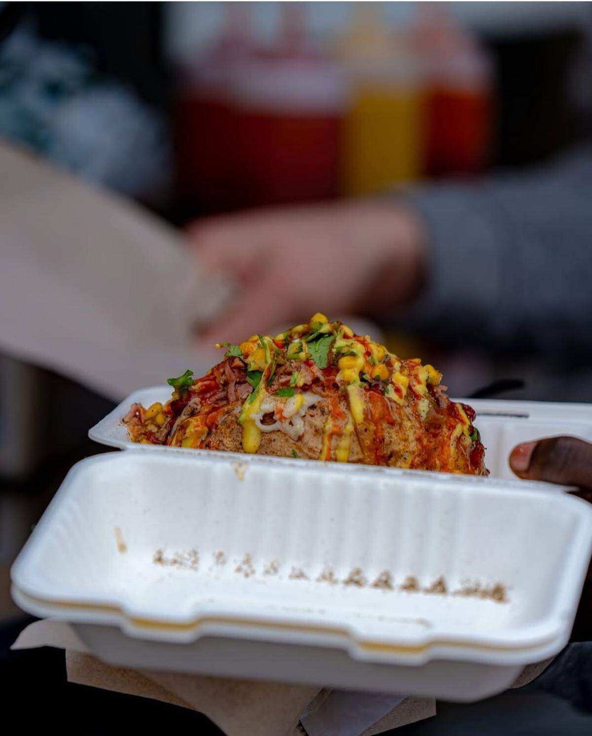 Spud Daddy served its loaded baked potatoes to football players prior to the Famous Idaho Potato Bowl in December. Pictured is a 40-count potato topped with smoked pit ham, creamy parmesan sauce, green onions, corn salsa and cilantro.