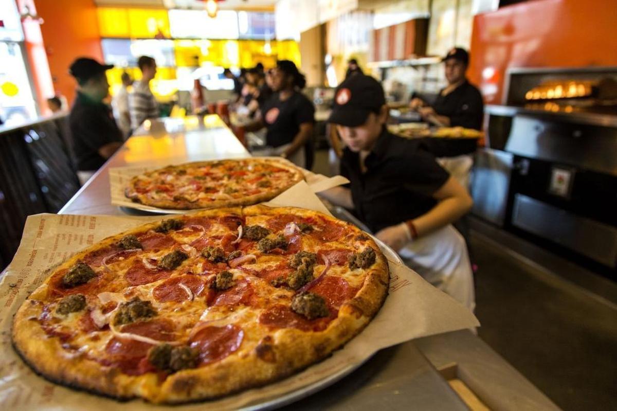 Customers can customize their own pizzas before they’re quickly baked at Blaze Pizza locations.