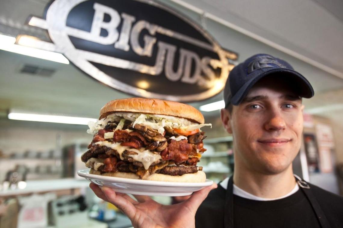 Hungry? Big Jud’s owner Chris Niederer holds the daunting Man Versus Food Burger.