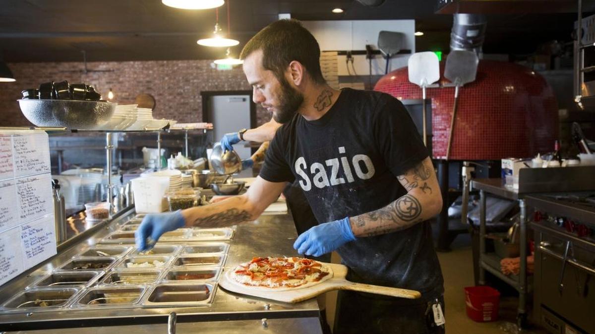 Dominic Cotroneo assembles a pizza at Red Bench Pizza (formerly Pizzeria Sazio) on the Boise Bench.