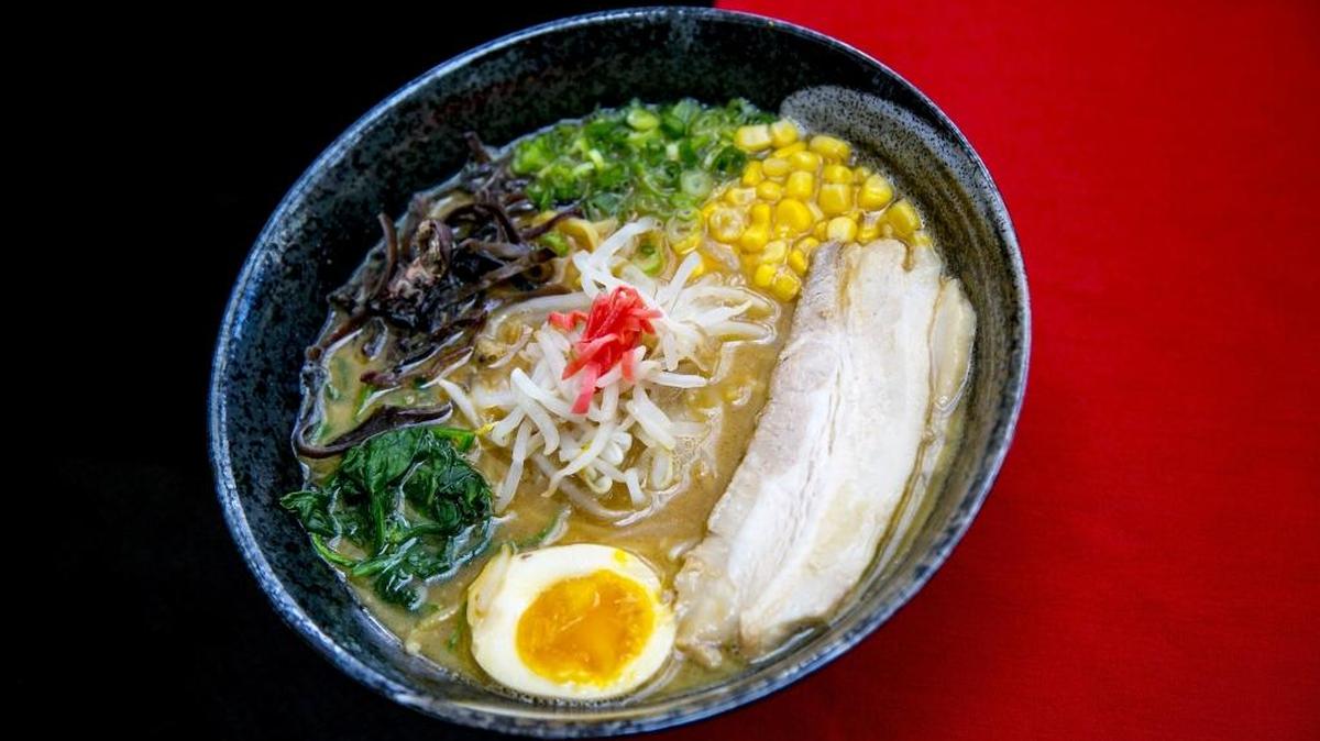 Ramen Sho: The tonkotsu ramen, a bowl of wheat noodles in broth, with pork belly, wood mushrooms, spinach, scallion, bean sprouts, threads of pickled ginger and a lightly boiled half egg.