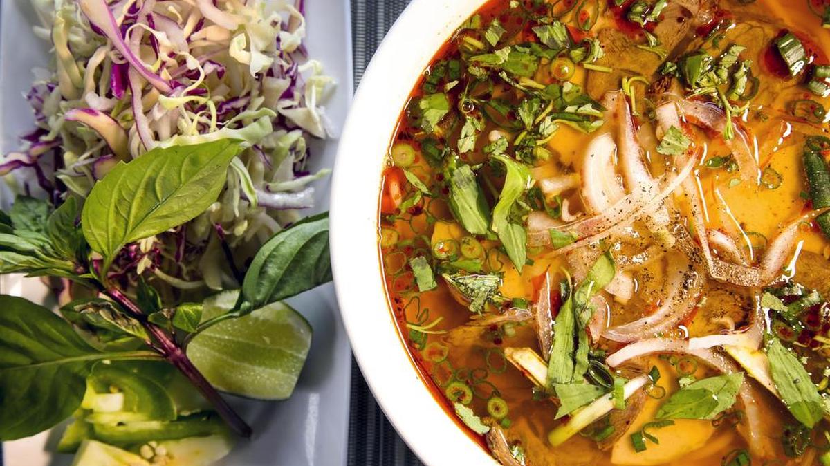Pho Tay Boise brings you Bun bo Hue, a famous spicy central Vietnam dish served in a large bowl that includes noodles, tender beef shank, pickled veggies, cucumber and fresh herbs. Ingredients on the side include fresh greens, lime and sliced jalepenos.