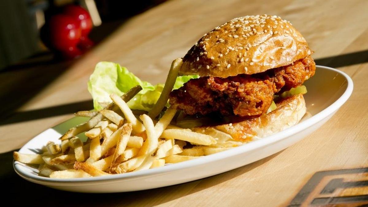 A spicy Nashville chicken sandwich with fried chicken, pickle, mayo and fries, photographed shortly after Grit American Cuisine opened in 2015.