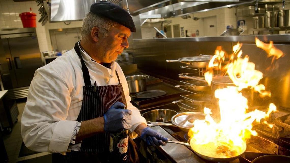 Chef Franck Bacquet prepares an order of monkfish Provencal.