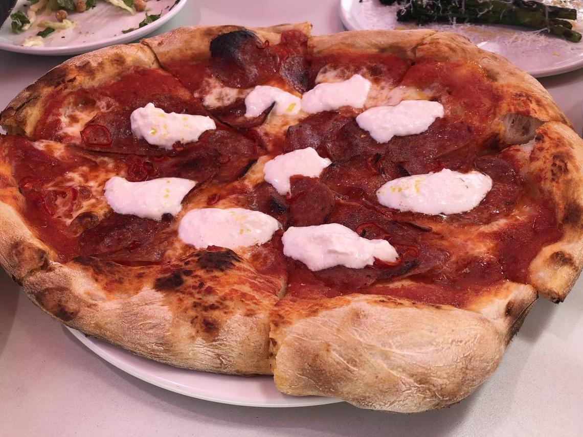 The Bronco pizza is salumi, pickled fresno chilies, and burrata on Bianco DiNapoli tomatoes.