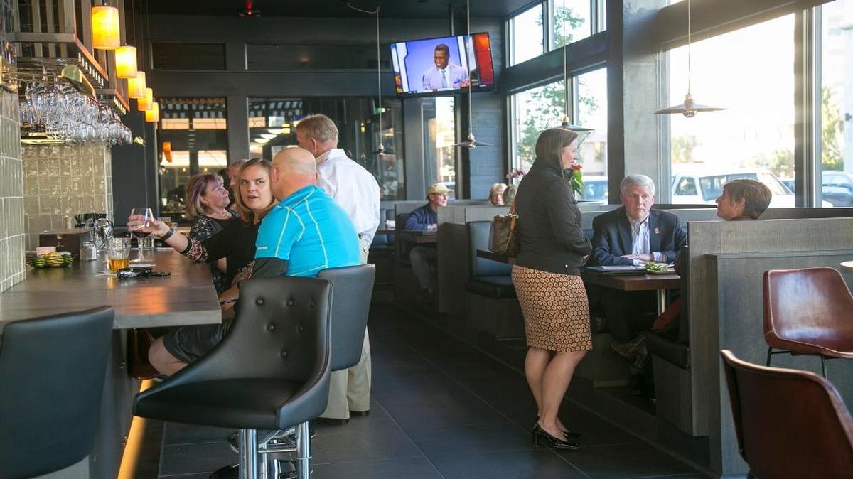 Patrons fill the bar area during happy hour at the Owyhee Tavern in Boise, which plans to add a brunch menu in March.