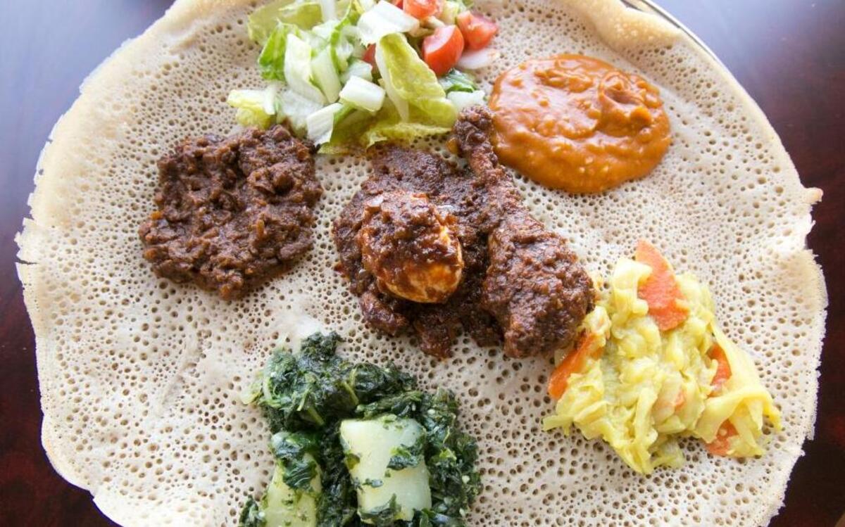 Kibrom’s is back in action with Ethiopan and Eritrean food. Pictured: boiled egg and spicy sauce (in the middle) and then clockwise from top: side salad, shiro (ground chickpeas with spices), alicha (cabbage, carrots, potato and spices), hamli kelwa (spinach and potato) and beef with spices.