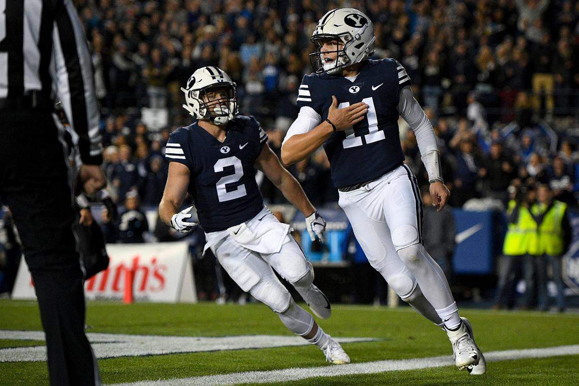 BYU quarterback Zach Wilson (11) celebrates his touchdown with running back Matt Hadley (2) on Oct. 13 against Hawaii at LaVell Edwards Stadium in Provo, Utah.