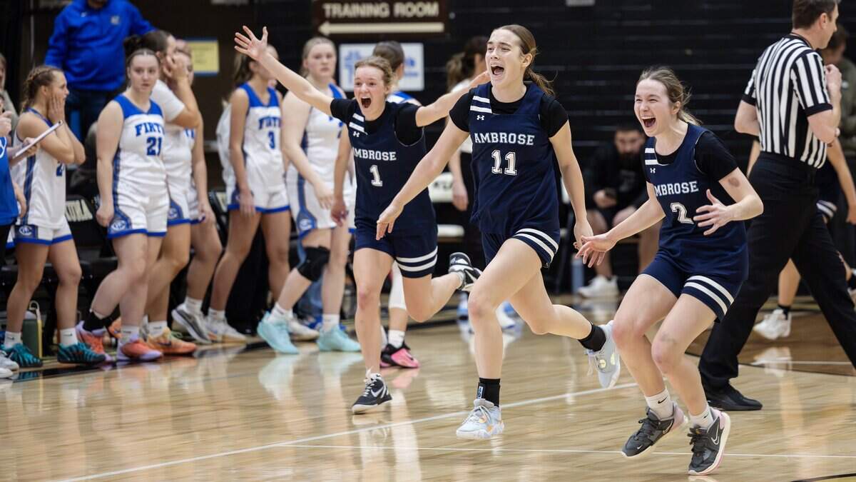 Ambrose players celebrate their 3A state tournament semifinal win against Firth at Kuna High School, Friday, Feb. 20, 2026. Ambrose won 57-54. Pictured from left: sophomore Claire Johnston, sophomore Amelia Alexander and junior Annelise Curran.