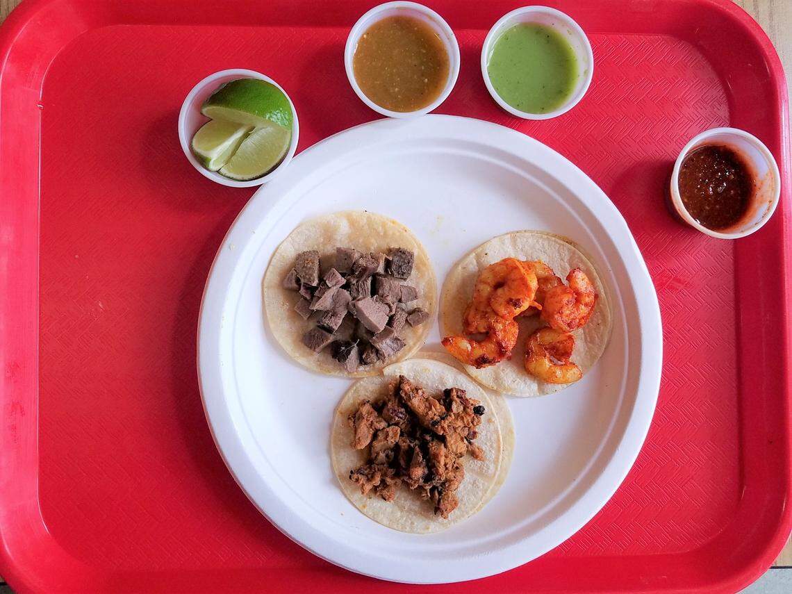 Here’s what tacos look like at El Faro. You take them to a condiments bar and doctor them up.