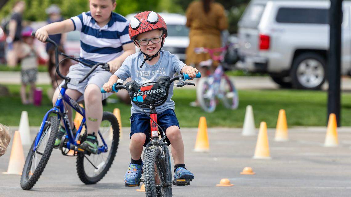 Lincoln Parkinson, 4, rides his bicycle on an obstacle course at Kleiner Park in May.