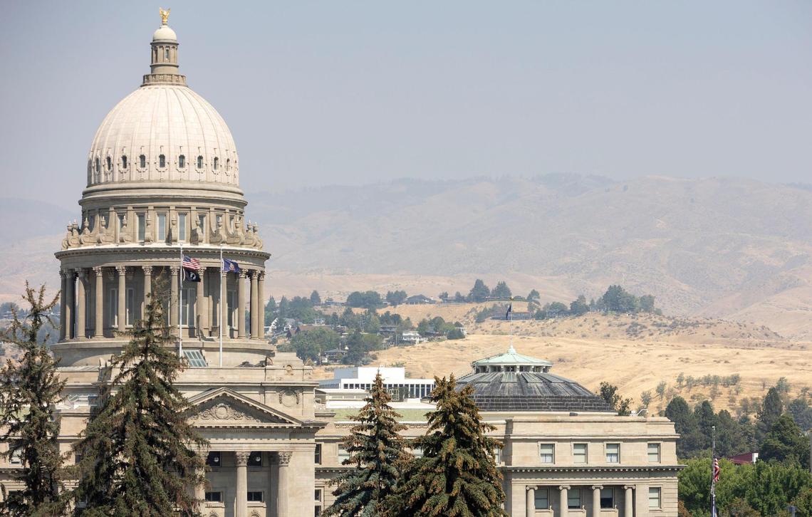 Smoke settles in over the foothills, seen beyond the Idaho State Capitol in Boise on Thursday, Sept. 1, 2022.