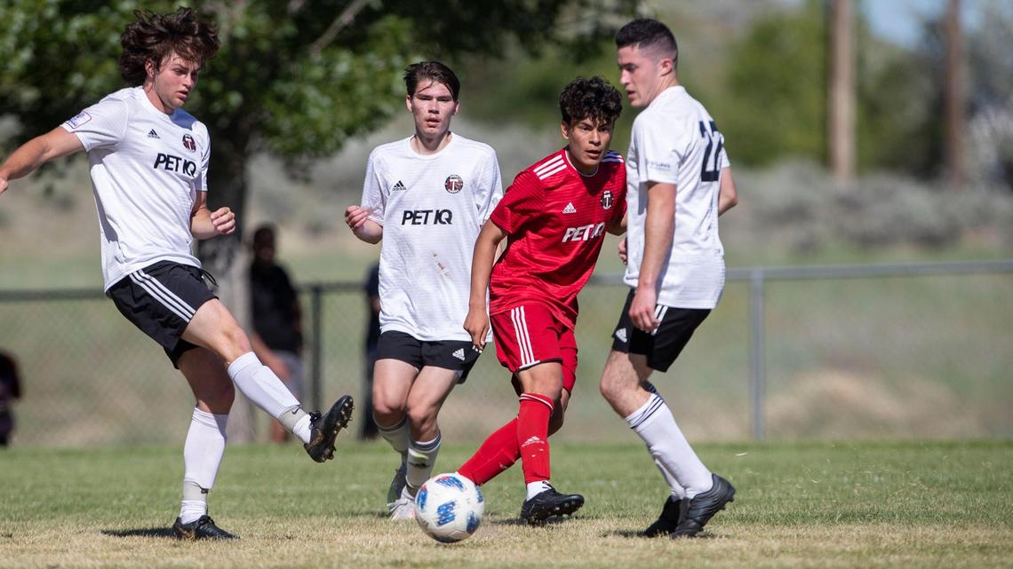Damian Arguello cuts a pass through three defenders to assist U-19 Boise Timbers teammate Dino Draganovic’s goal on Monday in the Idaho State Cup championship at the Simplot Sports Complex in East Boise.