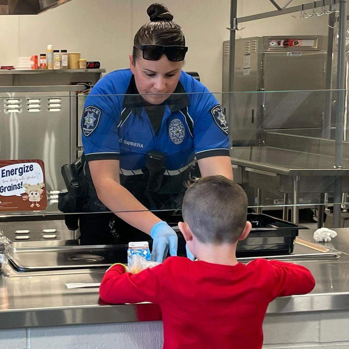Officer Danelle Barrera helps a student at Hunter Elementary School in Meridian. She is one 19 school resource officers assigned to West Ada Schools.