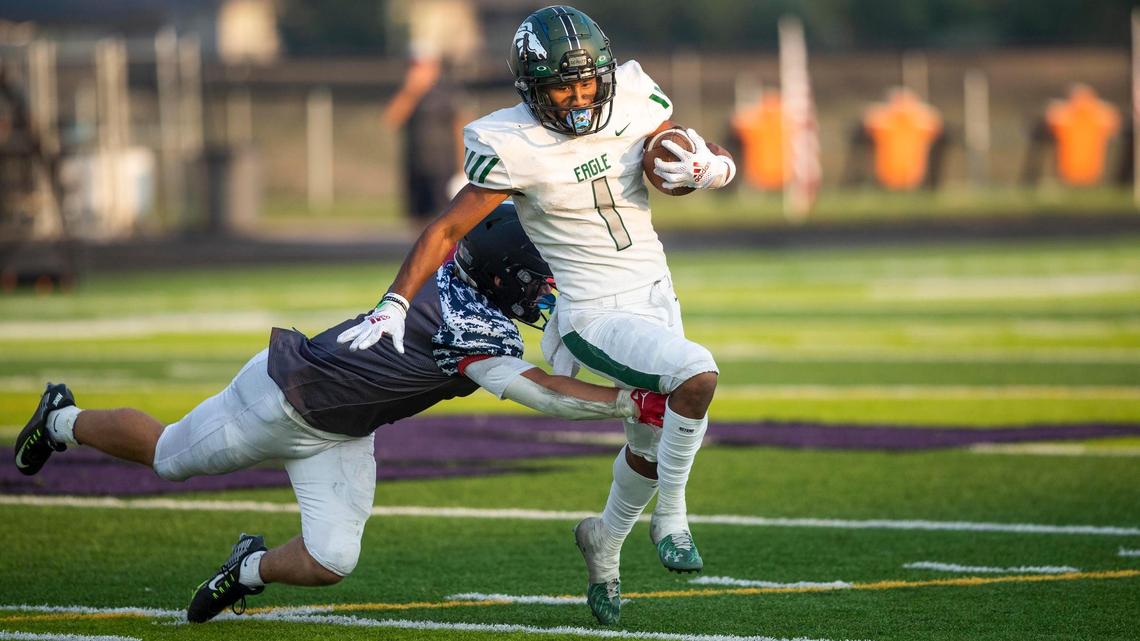 Eagle wide receiver Ian Duarte tries to slip past Rocky Mountain’s Art Williams on Saturday.