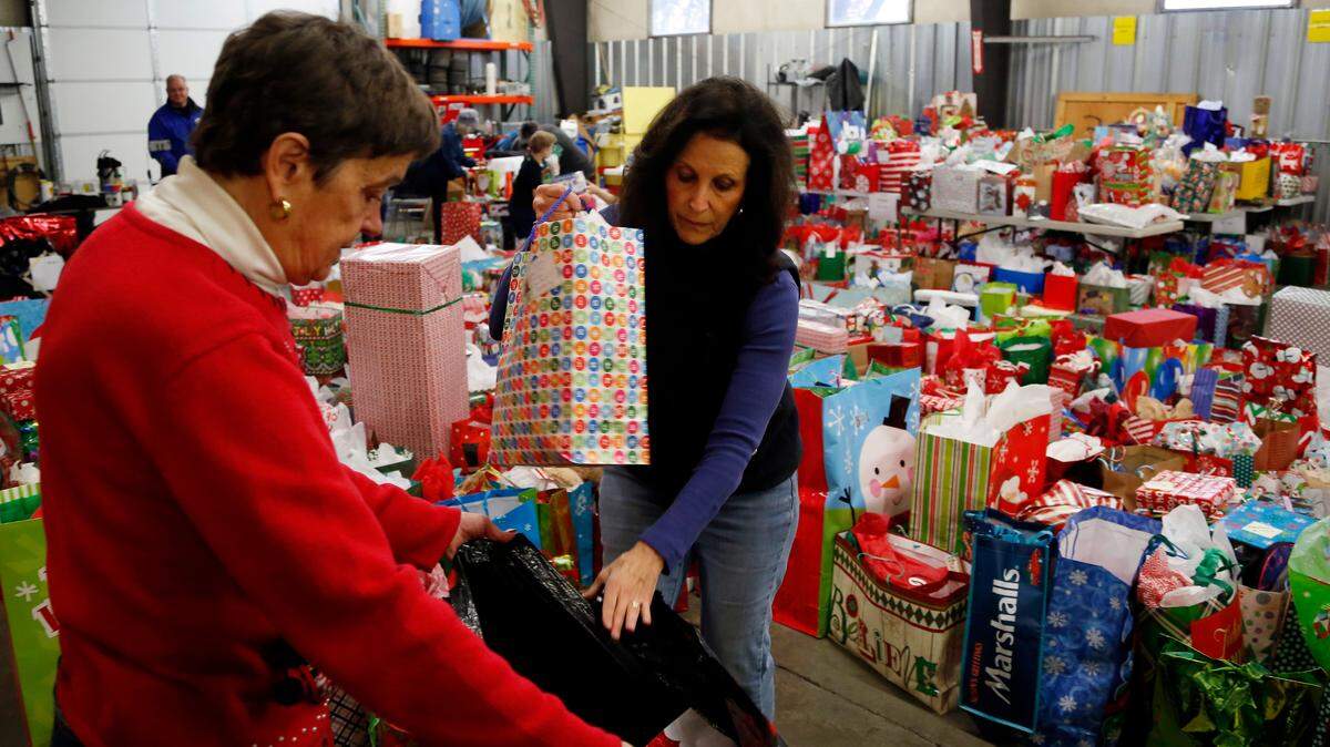 Susan Kelley (left) and Debbie Arnhols sort gifts in 2017 collected for people in nursing homes and for foster kids at the Servicemaster Restore warehouse in Meridian. The Soroptimists collected 1,166 gifts for 434 nursing home residents that year, and 1,278 gifts for 426 children in foster care.
