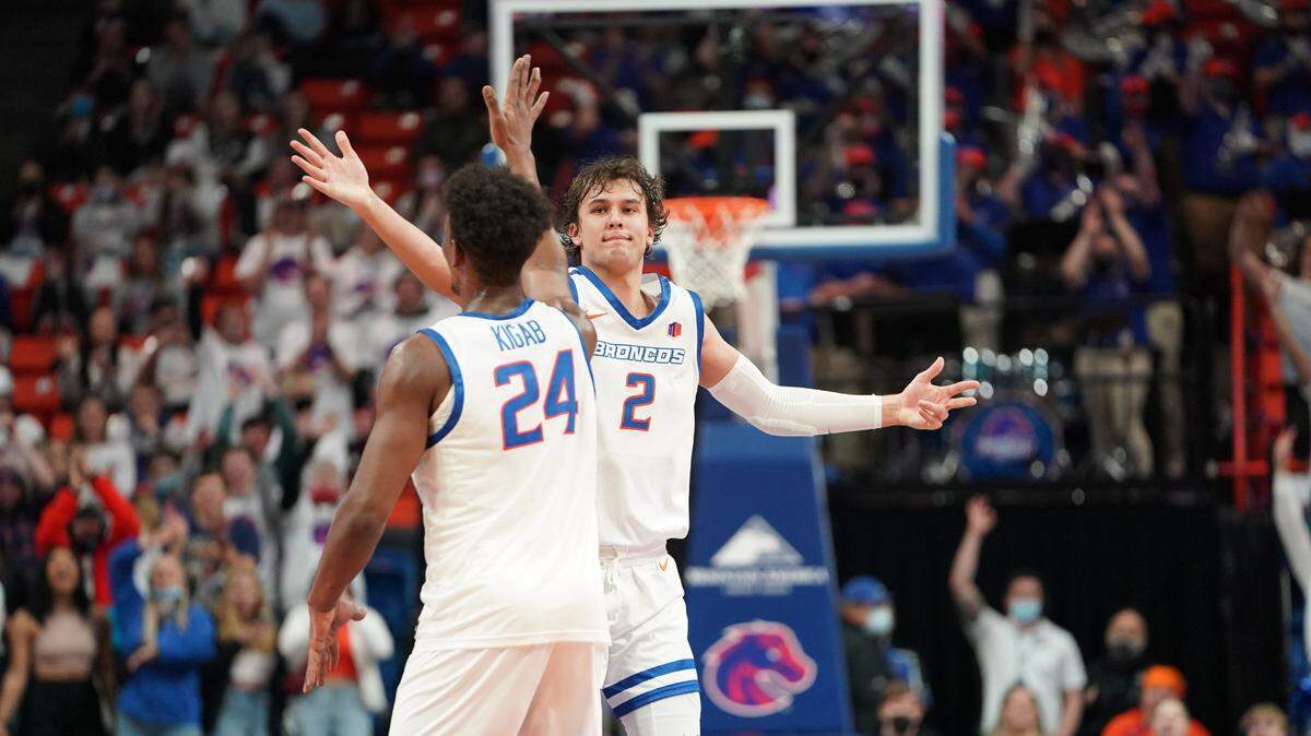 Tyson Degenhart, facing, and Abu Kigab celebrate during Boise State’s 76-60 win over San Jose State on Saturday at ExtraMile Arena. Degenhart scored a career-high 23 points.