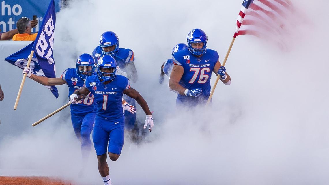 Boise State wide receiver Octavius Evans (1) leads the Broncos onto the field at Albertsons Stadium with the Dan Paul Hammer before a game against Marshall in 2019.