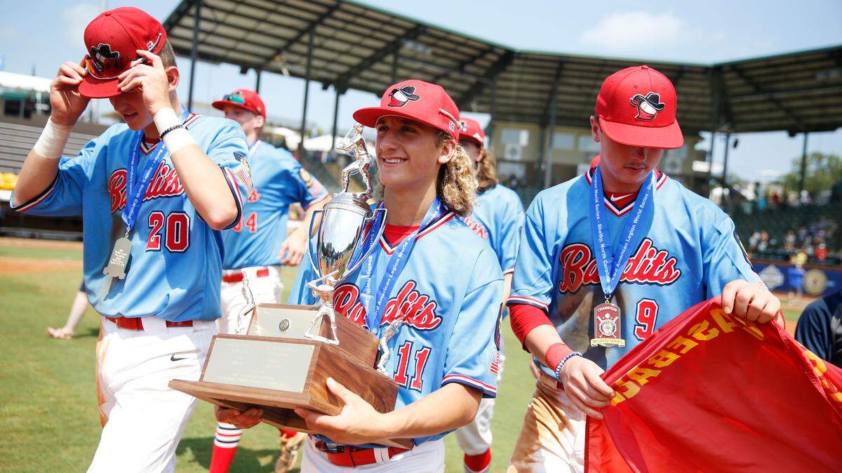 Kai Howell hoists the championship trophy after the Idaho Falls Bandits beat Fargo, N.D., 5-3 for the American Legion World Series championship.