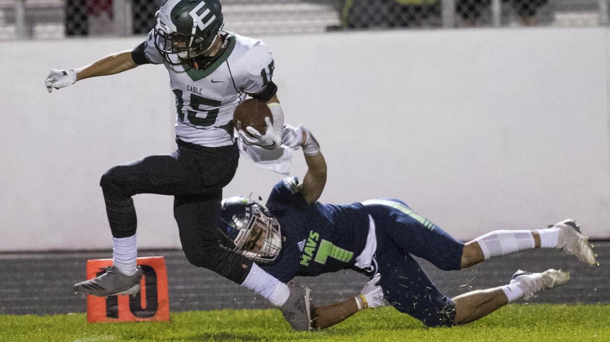Eagle wide receiver Kaden Baskett keeps his feet alive and in bounds as Mountain View’s Jarin Baroli attempts to tackle him Friday night.
