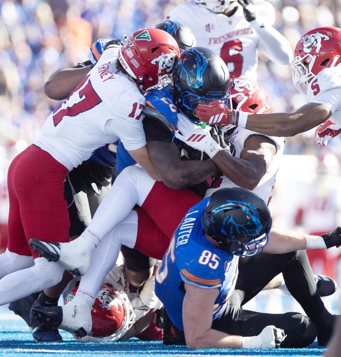 Boise State running back Sire Gaines gets stood up by Fresno State defensive back Ethan Tierney and nickleback Simeon Harris Fresno State leads Boise State 10-7 at the half of the game at Albertsons Stadium. November 1, 2025.
