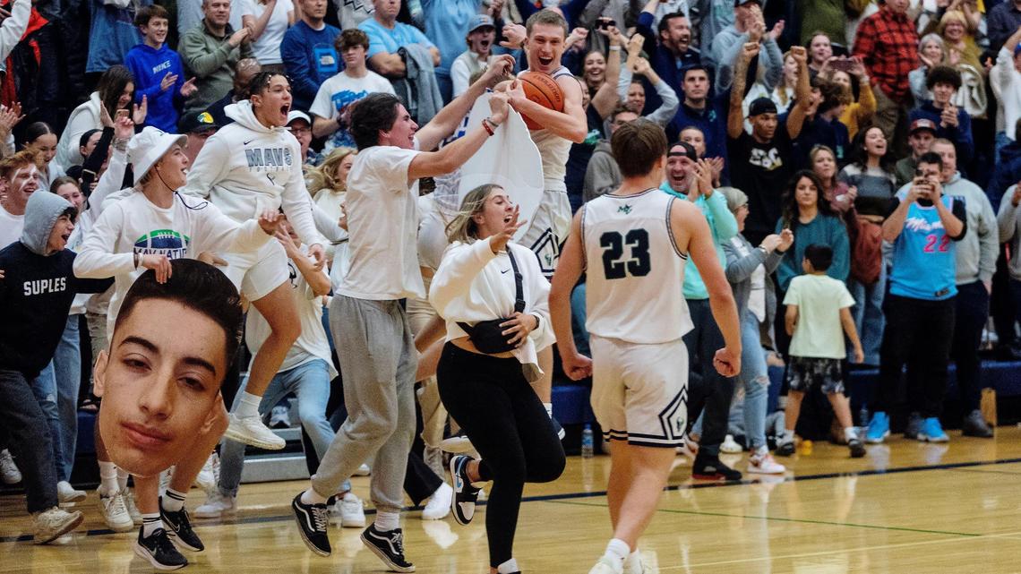 Mountain View students rush the court after the boys basketball team defeated defending 5A state champion Owyhee 66-65 on Thursday night.