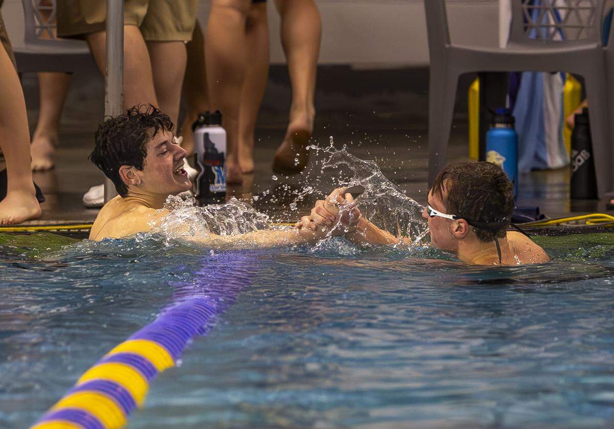 Boise junior Tyler Young, left, congratulates Meridian senior Josh Hart, right, after the 200-yard individual medley Saturday at the West YMCA. Hart set an all-class state record at 1 minutes, 54.27 seconds.