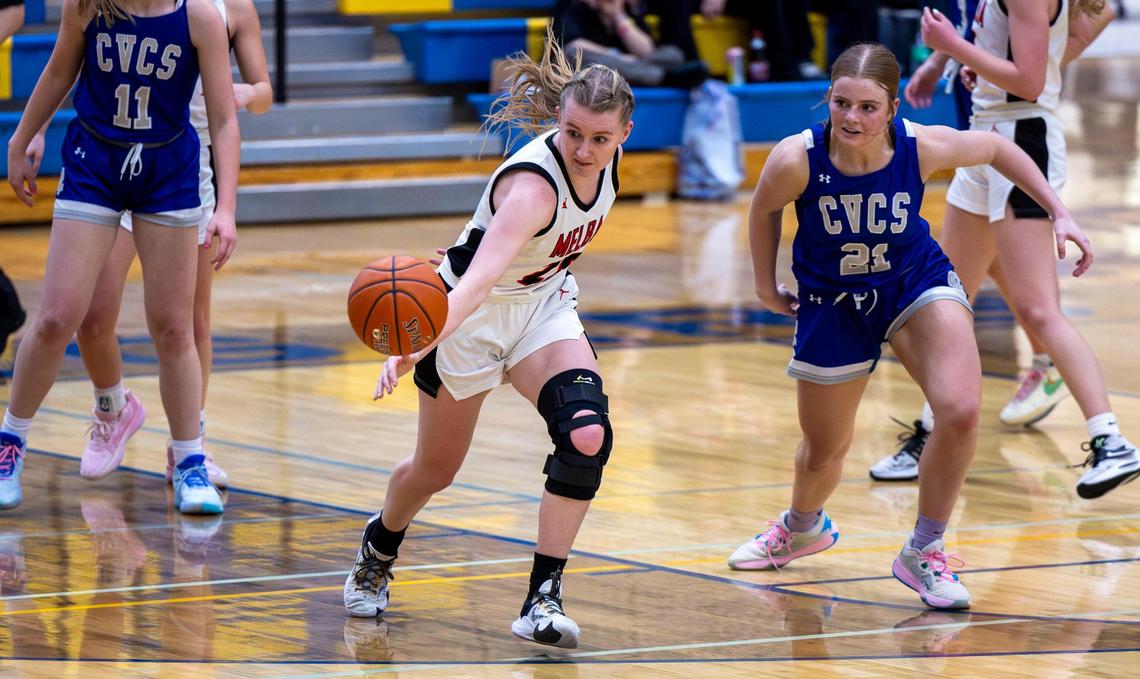 Melba forward Ellie Johnson steals a pass heading to Cole Valley Christian’s Ashleigh Oates in the third quarter of the 2A District Three girls basketball championship at Caldwell High.