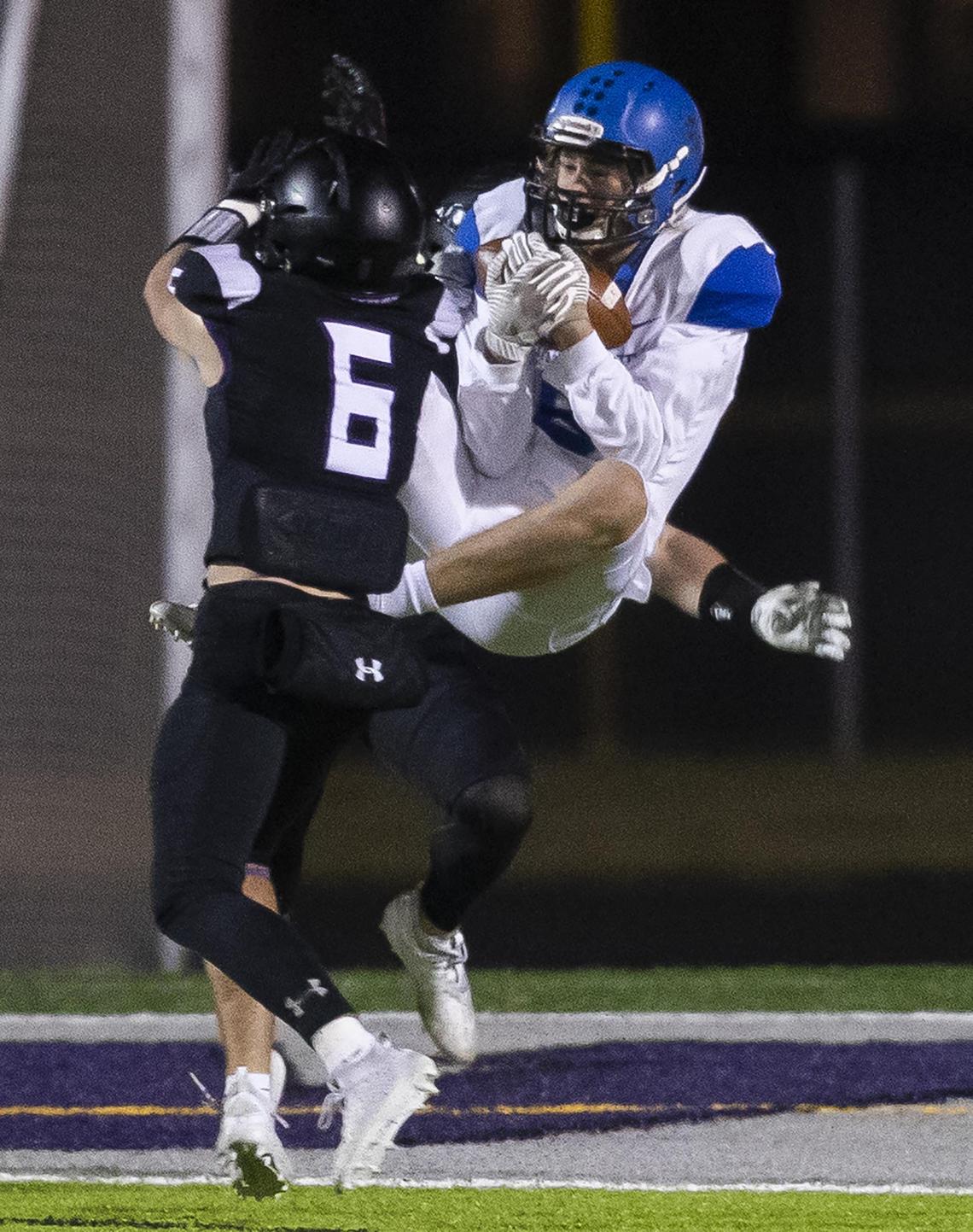 Timberline’s Elijah Keck hauls in a 36-yard touchdown pass in between two Rocky Mountain defensive backs to cut the lead to 13 late in the fourth quarter.