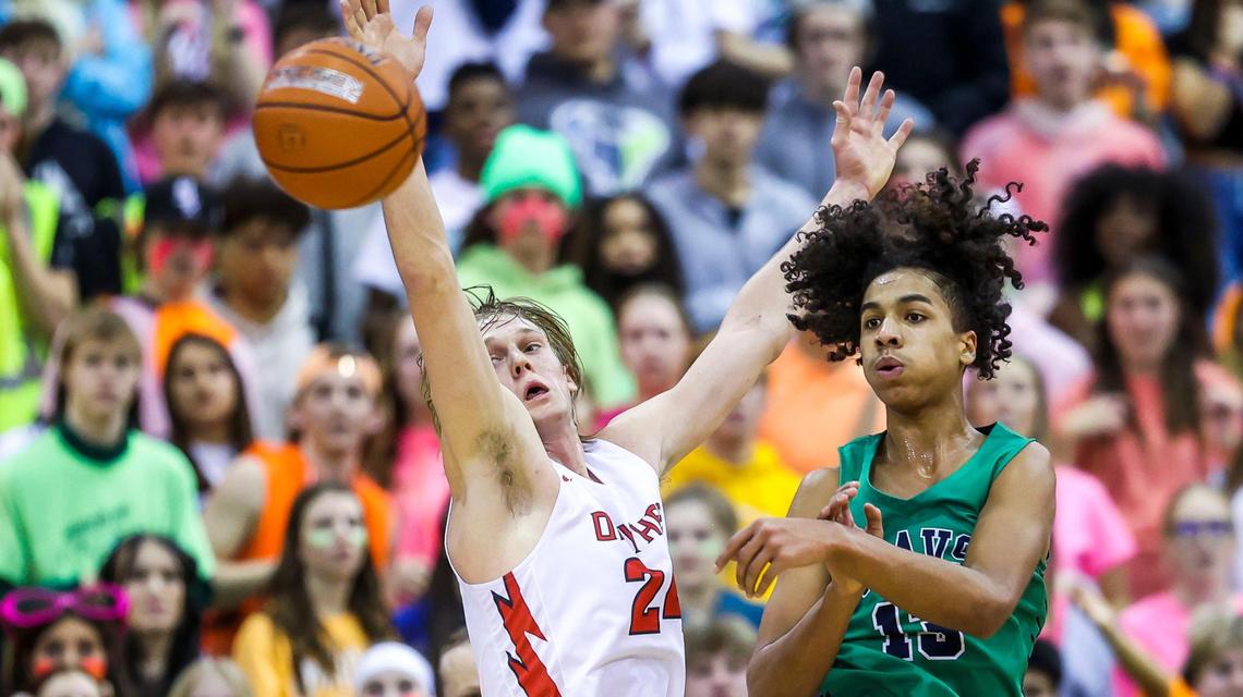 Owyhee guard Jack Payne fends off Mountain View’s Nate Ojuwku and tips the ball out to the perimeter in the first round of the 5A boys basketball state tournament Thursday at the Ford Idaho Center in Nampa.