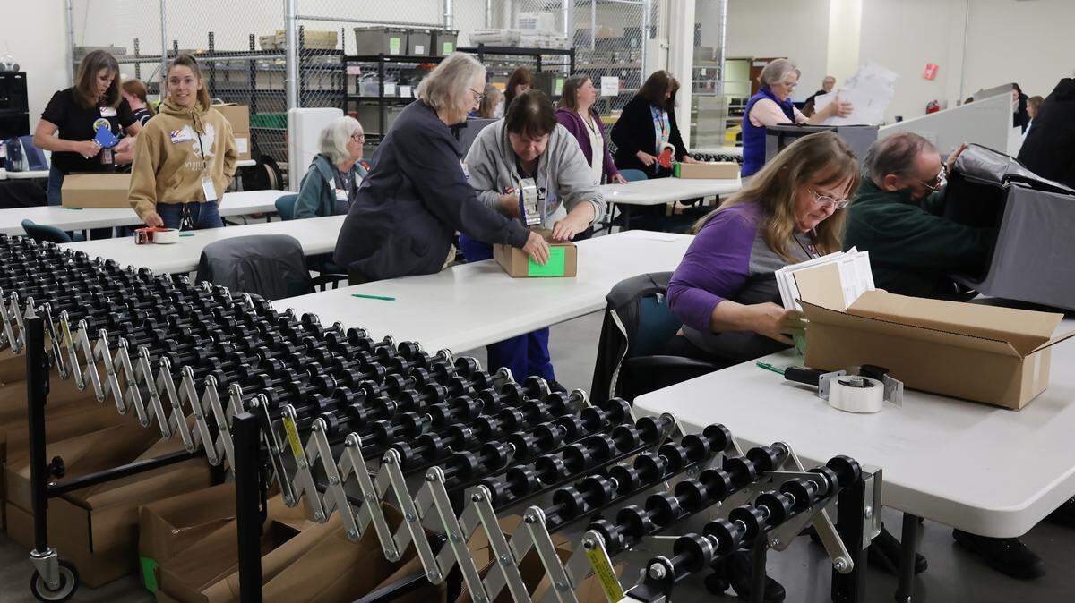 Workers process used paper ballots to be placed in storage. The Elections Office preserves these paper ballots for years.