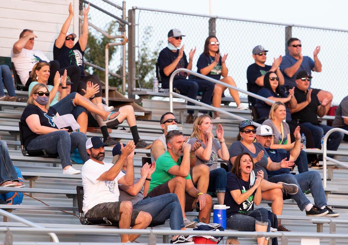 Mountain View High School parents cheer for their Mavericks football team against Eagle on Sept. 11 at Thunder Stadium in Eagle. Masks are supposed to be worn even outdoors when social distancing isn’t possible, but there’s less compliance there than indoors.