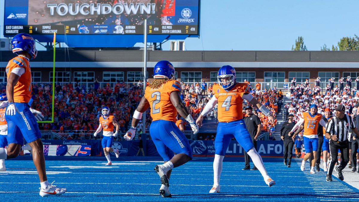 Boise State quarterback Maddux Madsen celebrates running back Ashton Jeanty’s 63-yard touchdown run on the Broncos’ opening play against Utah State at Albertsons Stadium.