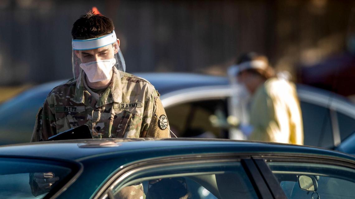 SPC Anthony Pittz with the Idaho Army National Guard collects information from patients waiting to be tested for COVID-19 in the parking lot of Saint Alphonsus Health Plaza in Meridian Thursday, Dec. 3, 2020.