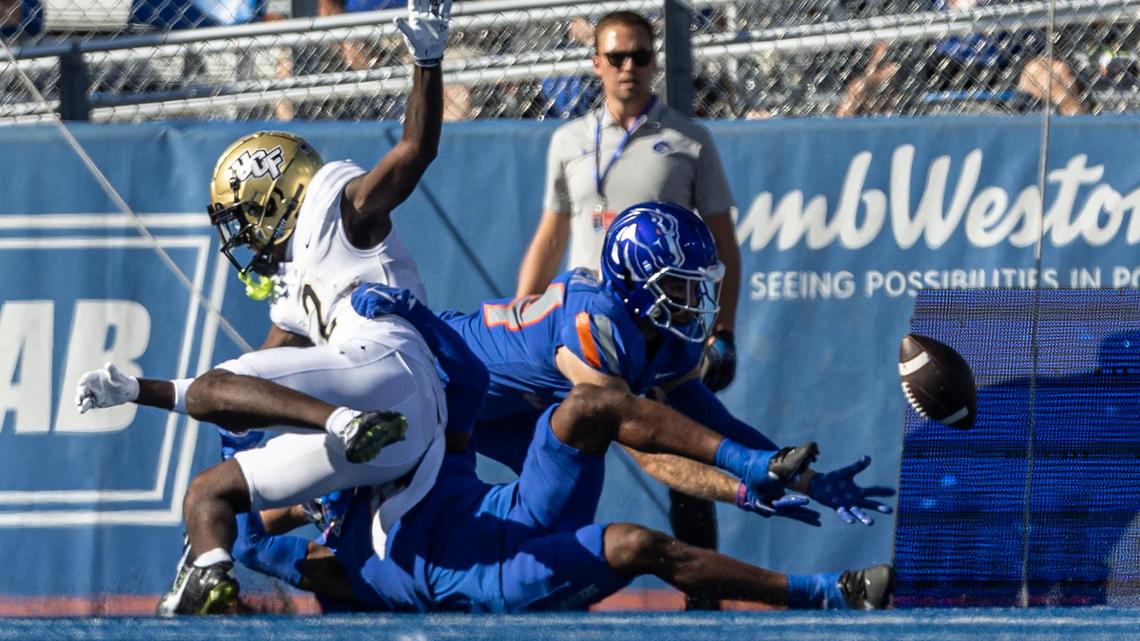 Boise State safety Alexander Teubner dives to intercept a deflected pass intended for UCF wide receiver Kobe Hudson on the game’s opening drive Saturday.