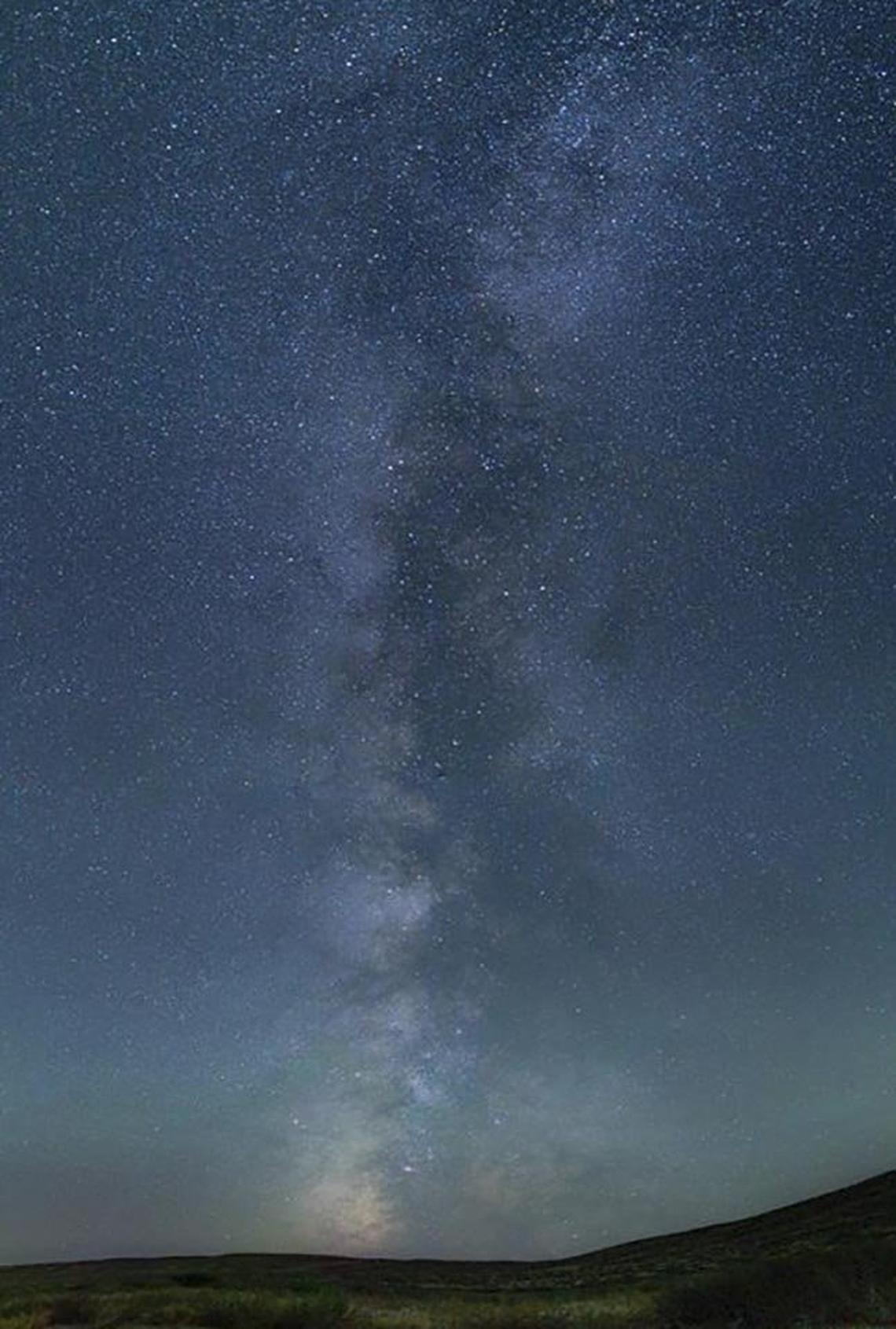 The Milky Way Galaxy looms bright in photographs unencumbered by light noise in the night sky at Bruneau Dunes State Park.